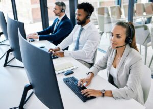 3 people on computers giving salon software support